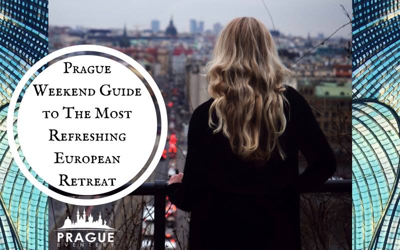 Blonde girl standing on the balcony watching the streets of Prague